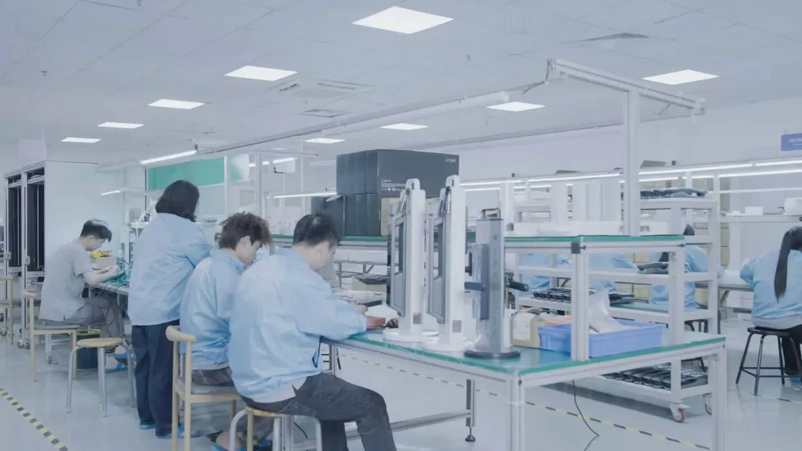 YOUNUO IET smart lock assembly workshop with production operators and inspection workstations